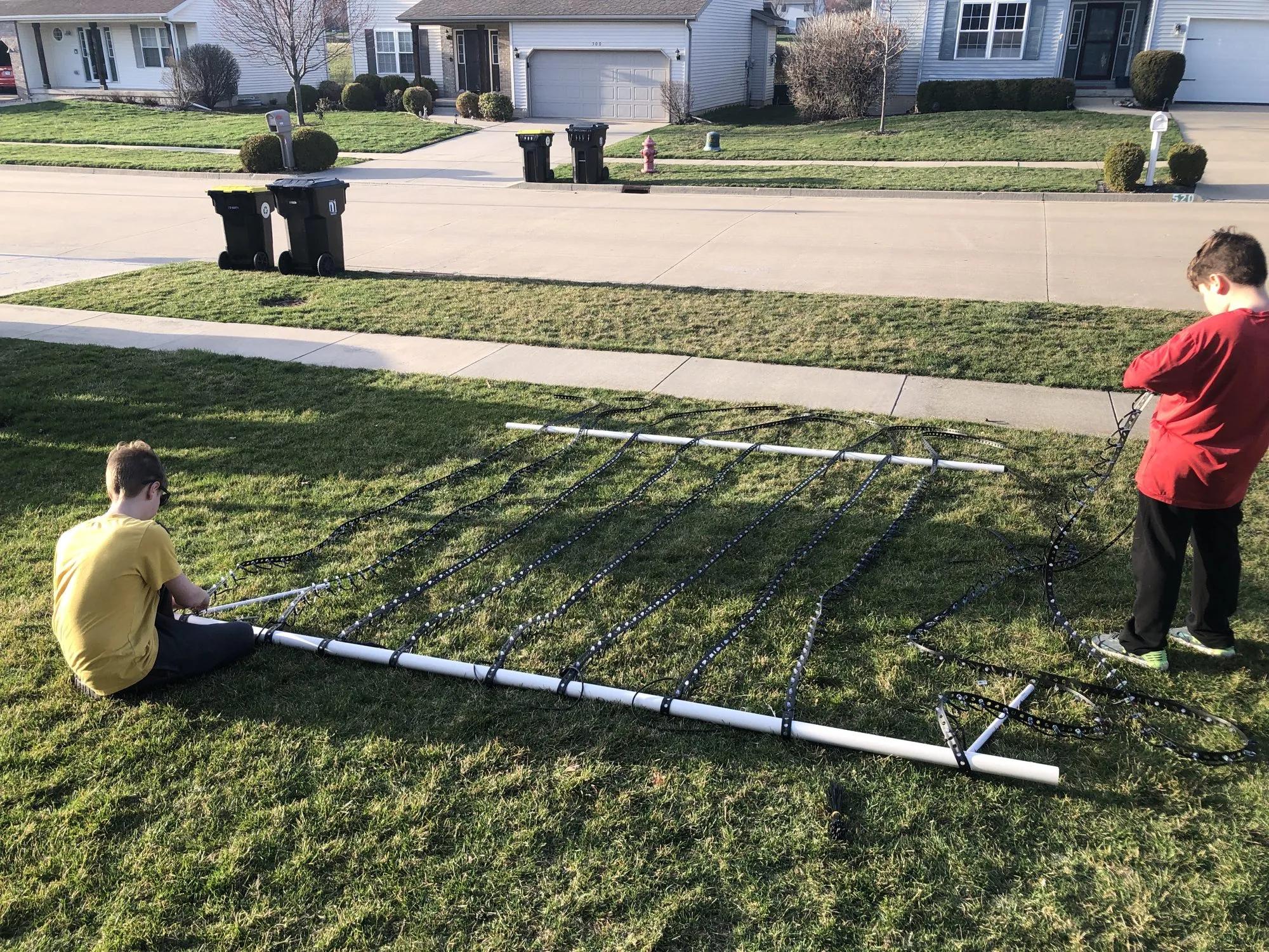 Max and Will building the Quarantunes show on the front lawn, 2020